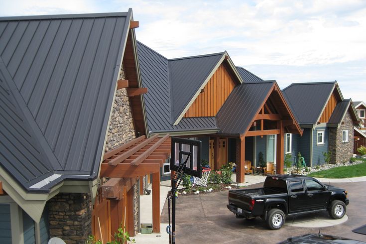 Row of luxury homes with standing seam metal roofs and wooden accents