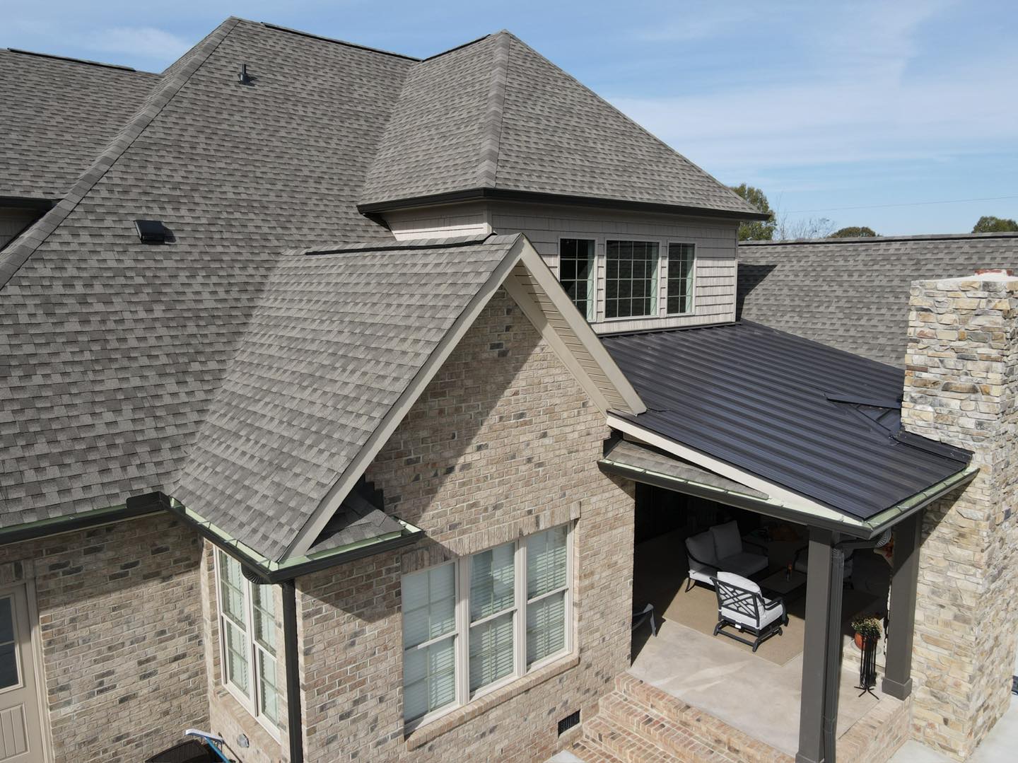 Brick home with multi-level architectural shingle roof